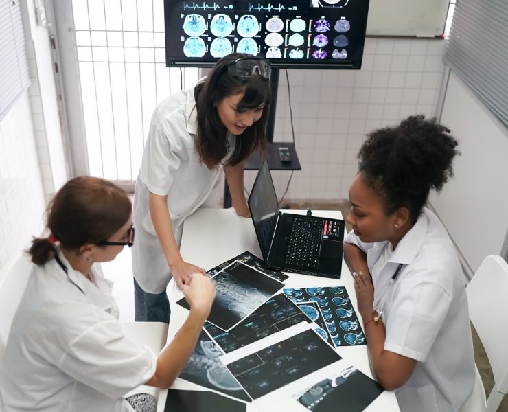 group of doctors looking at x ray on medical conference