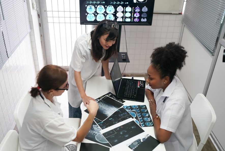 group of doctors looking at x ray on medical conference